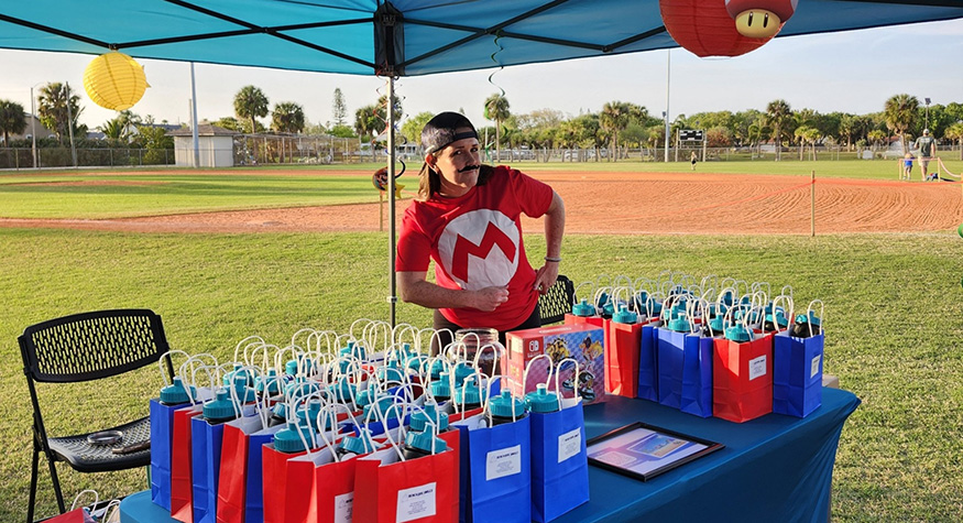 Dental team member at outdoor table with gift bags