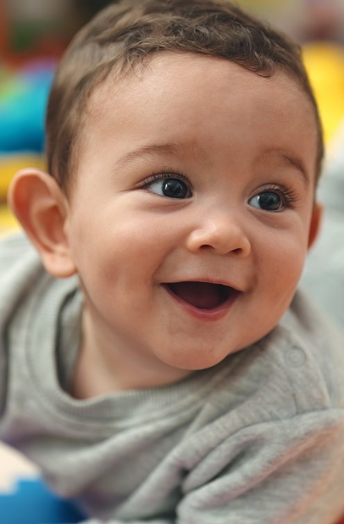 Baby with no teeth smiling after seeing dentist for infants in Satellite Beach