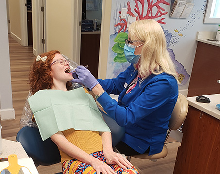 Young girl receiving treatment from pediatric dentist