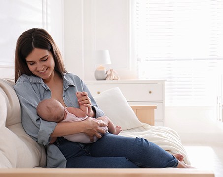 Happy mother feeding her infant